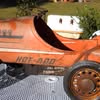 Close-up of an old, rusty orange snowmobile with the text 'HOT-400' on its side.